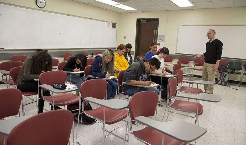 A group of students practices different posture in preparing to take a math test.